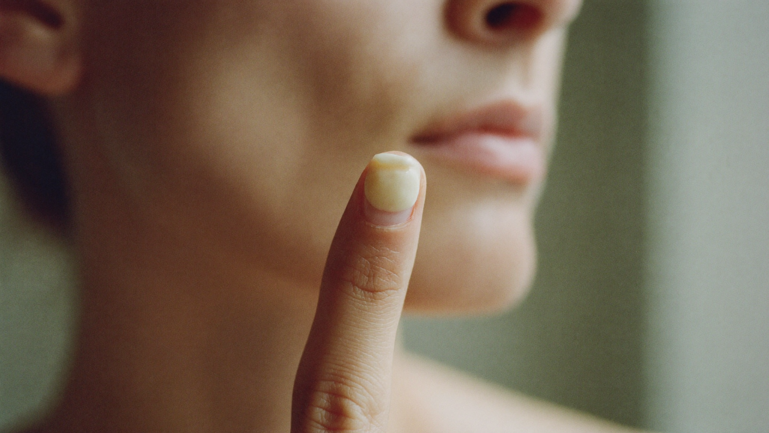 A pea-sized amount of cream on a fingertip, the correct dose for the whole face