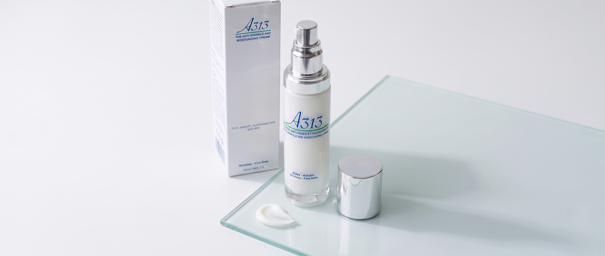 A313 Anti-Wrinkle Moisturizing Face Cream pump bottle beside a small dollop of cream on pale glass in soft daylight