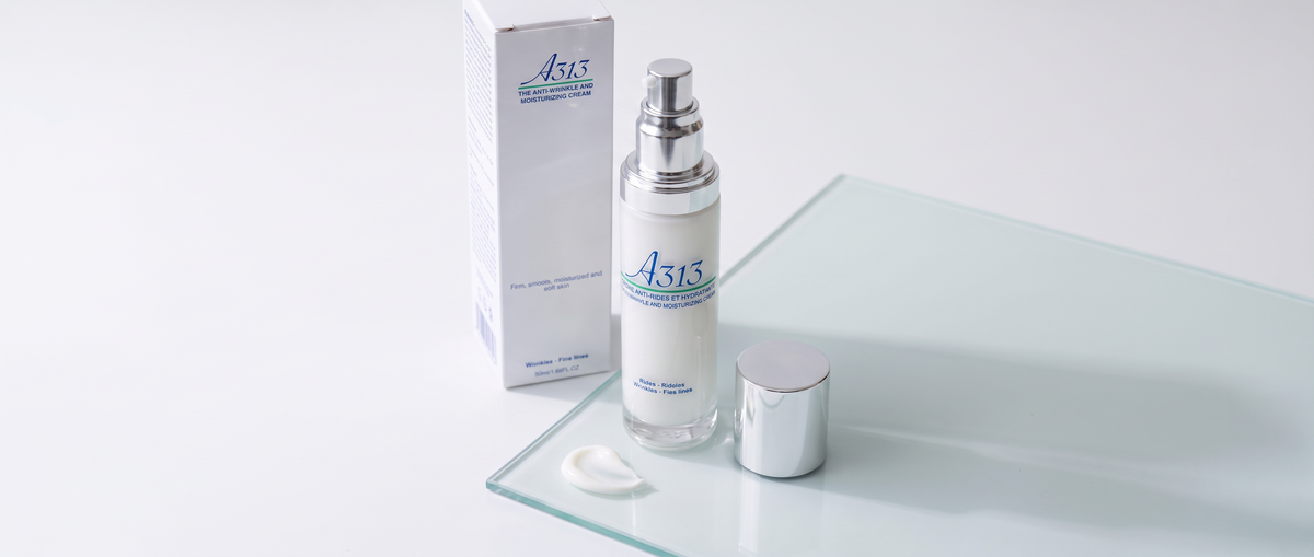 A313 Anti-Wrinkle Moisturizing Face Cream pump bottle beside a dollop of cream on pale glass in soft daylight