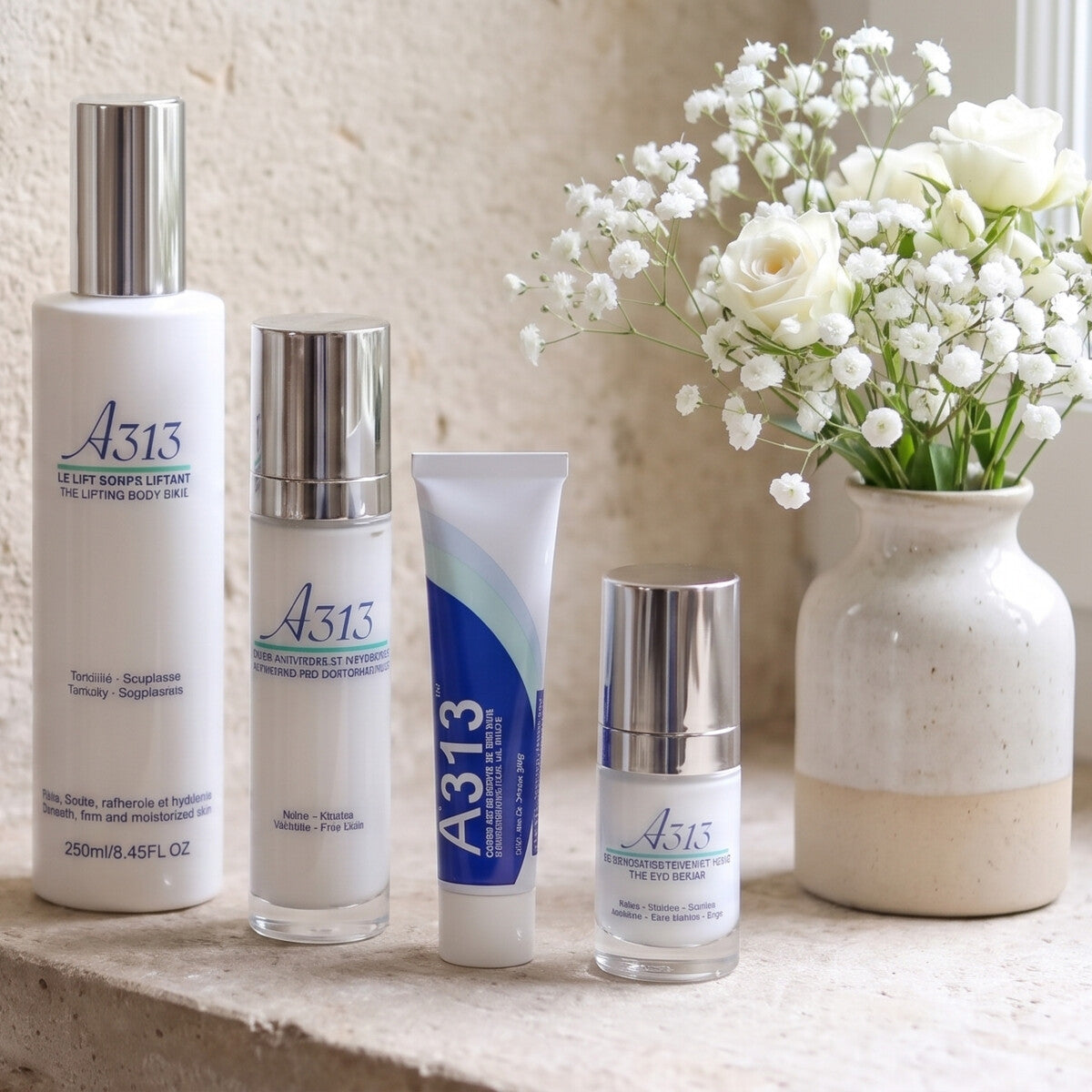 A313 skincare range on a stone windowsill with white flowers